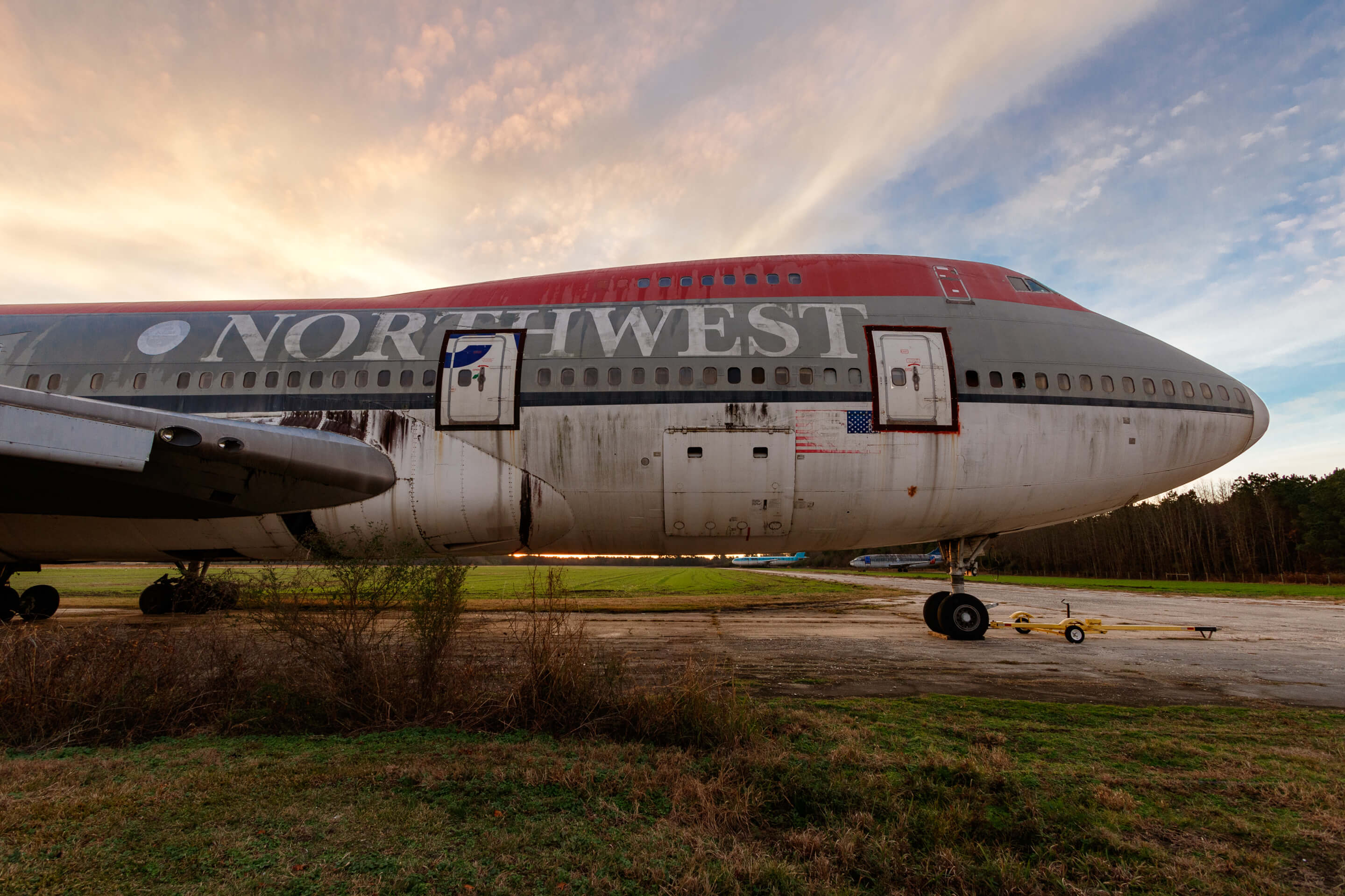 Northwest Airlines abandoned Boeing 747 during Christmas morning sunrise sitting on a decaying runway since 1999.